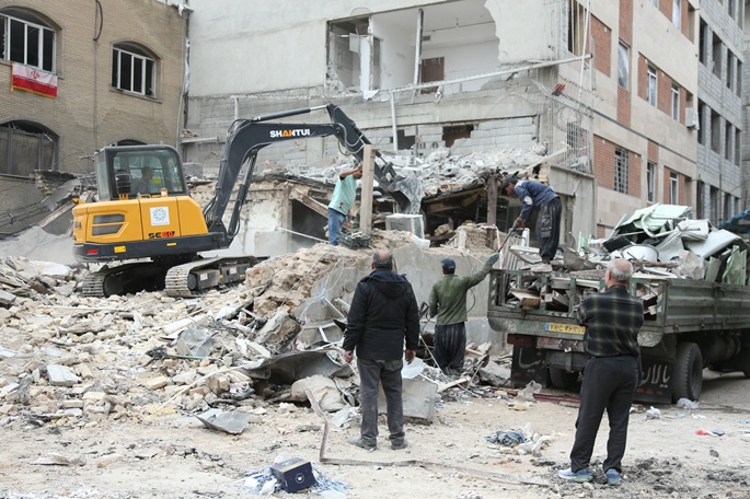 People clear the debris among destroyed buildings at a residential area in Tehran, Iran, March 15, 2026. Photo: Xinhua/Shadati.