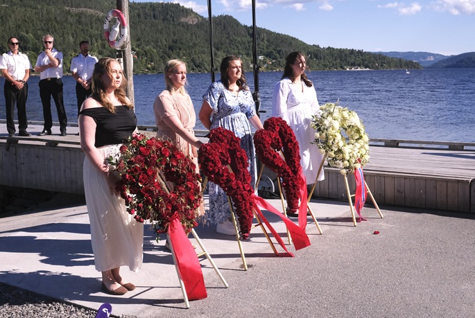 Representatives stand beside wreaths during a memorial event marking the 15th anniversary of the July 22, 2011 terror attacks on Utoya Island, Norway, July 22, 2026. Photo: Xinhua.